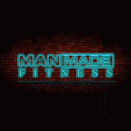 a neon sign that says, the word manamed fitness is illuminated in front of a brick wall
