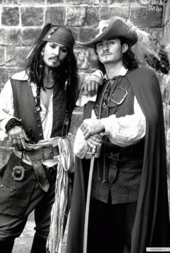 two pirates are dressed in fancy clothes