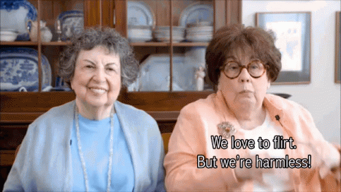 two older women with glasses are smiling together