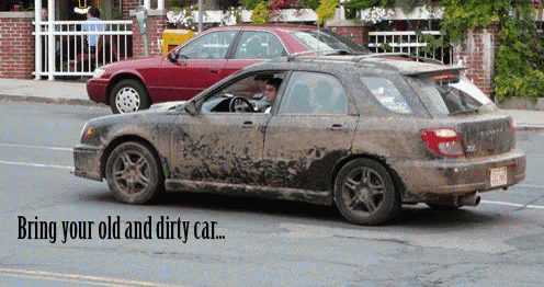 dirty car with its hood on is driving in the street