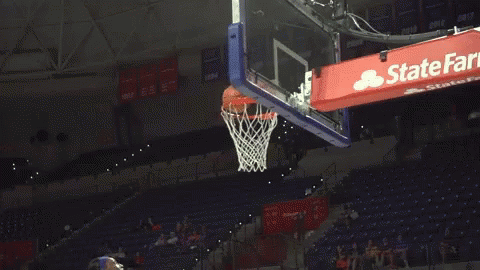 a basketball goal with a blue state farm banner above it
