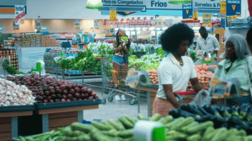 an african american woman shopping in a produce market