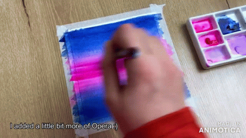 someone is painting a piece of art that has pinks and purples on it