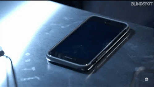 an old cell phone is left on the table