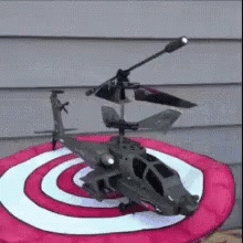 a purple and white target with a metal helicopter