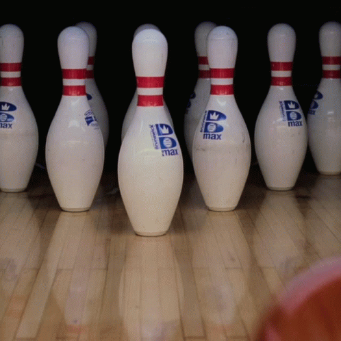 six bowling pins lined up in a row
