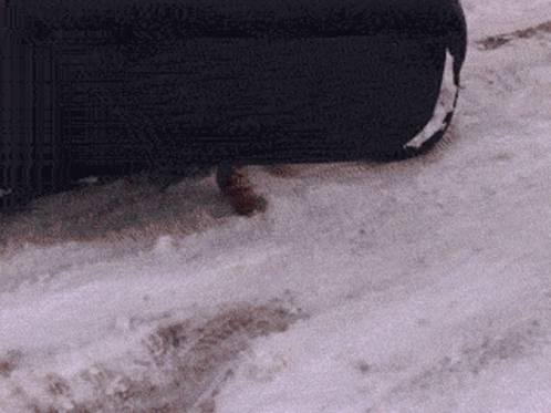 a suitcase sitting on the ground covered in snow
