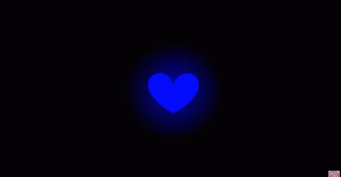 a blurry image of a red heart in the middle of a dark night