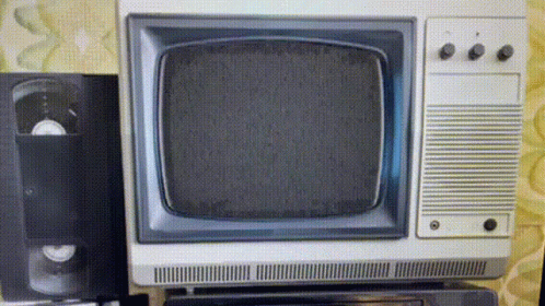 an old television set in front of two speakers