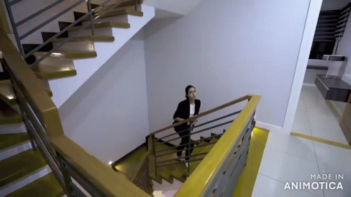a man is standing on some stairs in an apartment