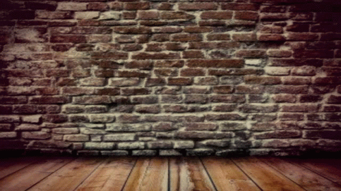 an empty brick wall in a dark room