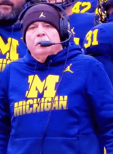 an orange hoodie is shown with the michigan football team wearing it