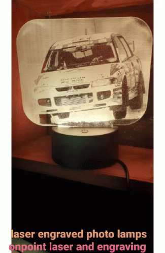 a white car being projected on top of a projector screen