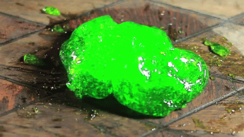 a green substance is sitting on the floor