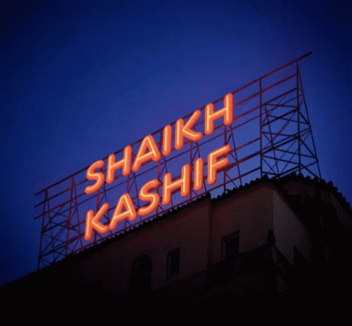 a neon sign lit up over an office building