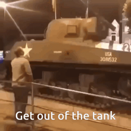 a man walking near a tank on display