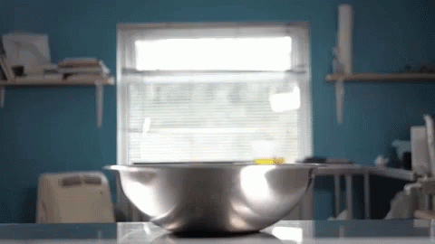 a shiny steel bowl sitting on a counter