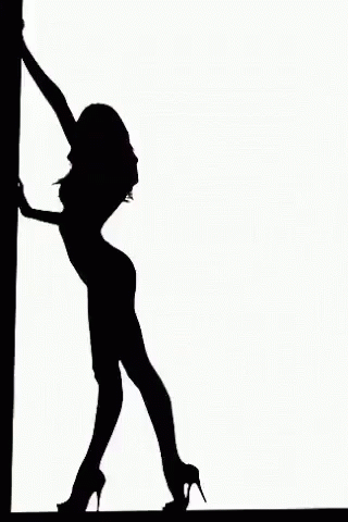 a woman standing against a pole with a high heeled shoe