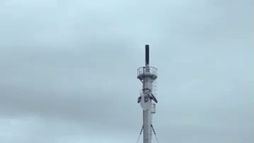 a small radio tower on top of a hill