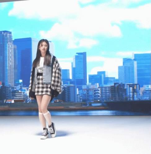 a woman wearing a checked shirt and skirt walking in front of a cityscape