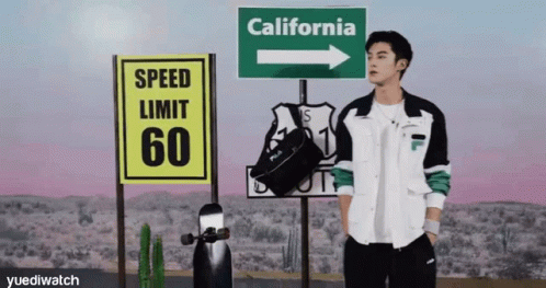a man standing in front of street signs that read speed limit 60