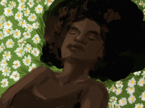 a woman sleeping on top of a bed covered in flowers