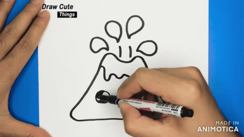 a hand holding a pen with a drawing on it