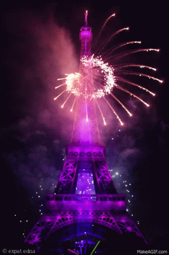 fireworks illuminate the eiffel tower against a black night sky