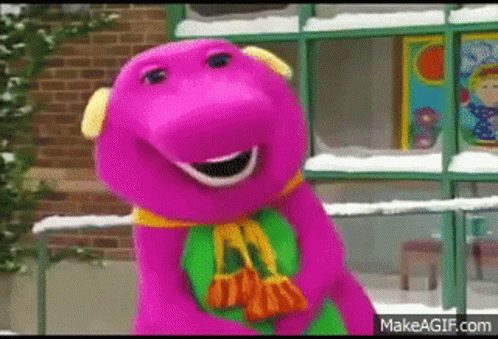 the purple dinosaur is wearing a green scarf