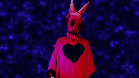 a skeleton with devilish horns is seen in front of a red background