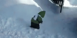 snowboarder in green jacket going down a slope