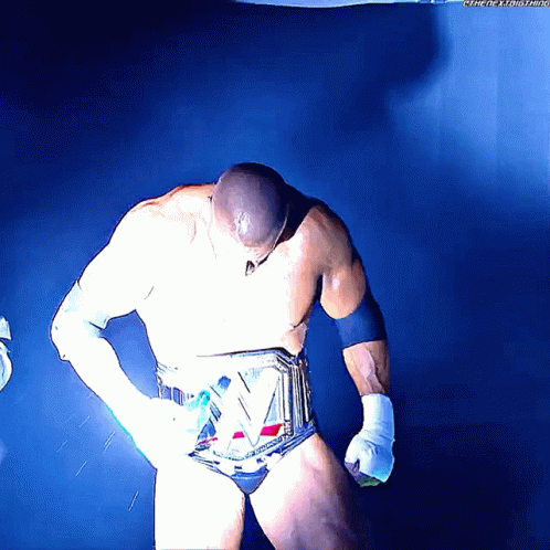 an animated image of a male wrestler holding his hands on his hips