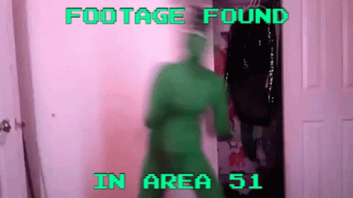a person in green with their foot up in front of the camera