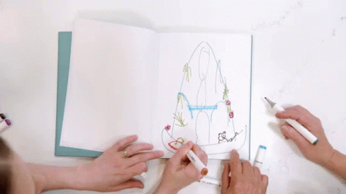 two young people are coloring an object on paper