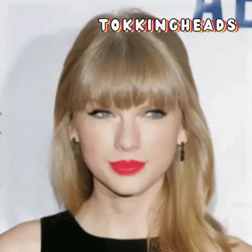 taylors hair and bangs are very long, while the image looks like she's looking