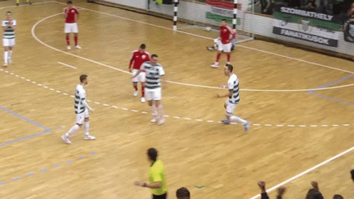 a bunch of people playing soccer on a court