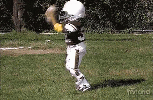 a young football player about to catch a ball
