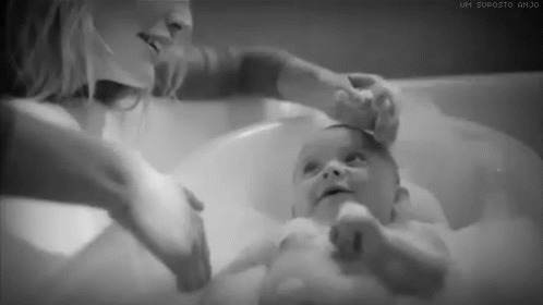 mother takes a bath to help her baby relax and play with each other