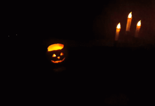 a fake skeleton pumpkin with some glowing candles on it