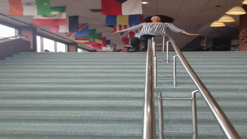 woman standing on stairs near handrail at indoor event