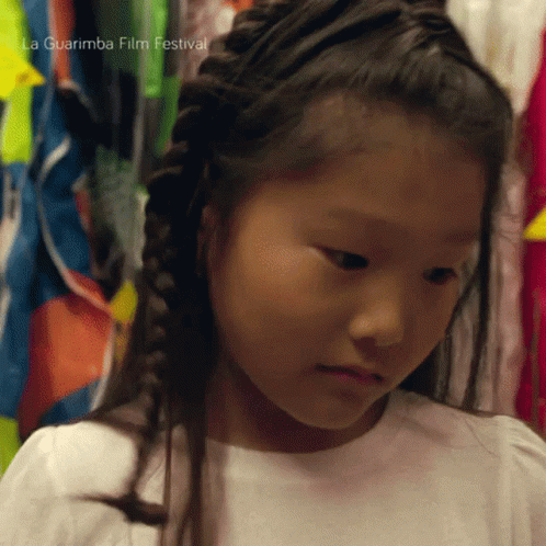 a little girl has long ids in her hair