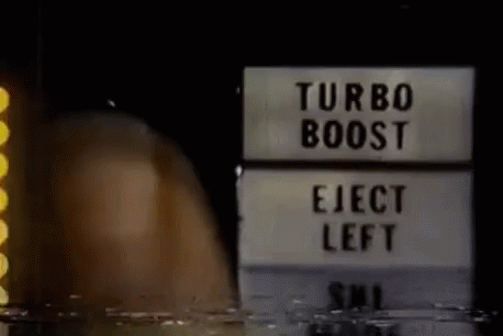 this is a sign in the dark that says turbo booster and elect left