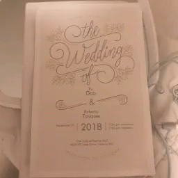 a wedding program being displayed on a paper
