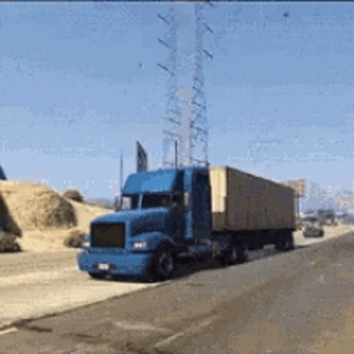a truck is driving down the road by telephone poles