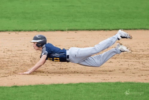a person diving to the base in a baseball game