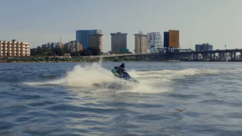 a man rides a wave on his jet ski