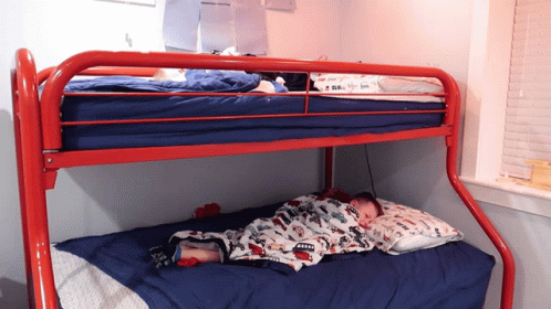 two beds are positioned on a metal bunk bed