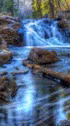a blurred view of a small waterfall from water