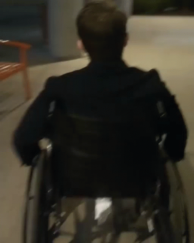 a man in a wheelchair with his back turned