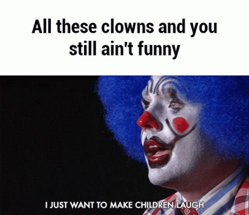 an orange clown wearing blue makeup looks up and smiles